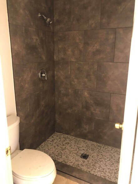 Upstairs bathroom's shower, separated from the sink area by a door - 9594 Easter Way
