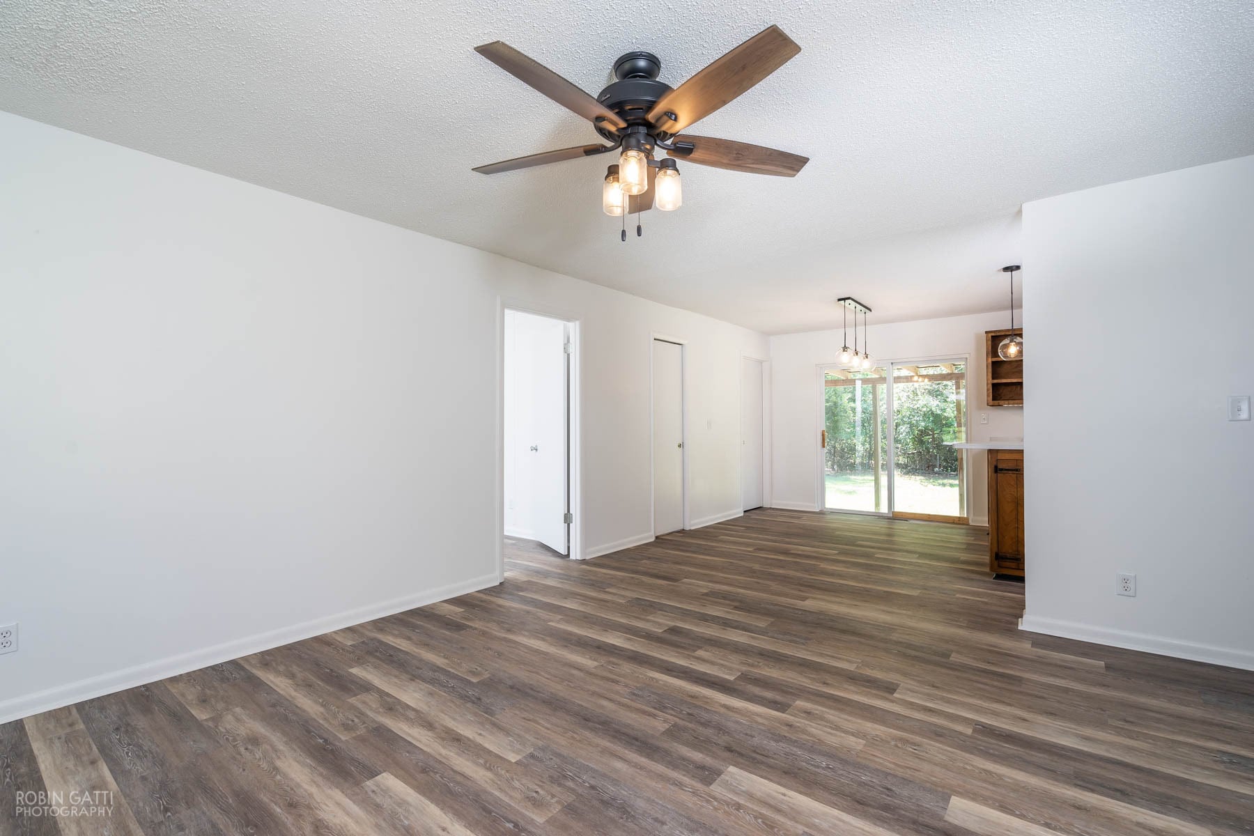 Living room with new flooring throughout and new lighting fixture - 502 Cherokee Court