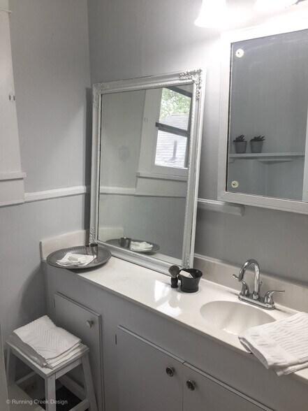 Full bathroom has long vanity and full tub/shower combo. - 328 E Walnut Street