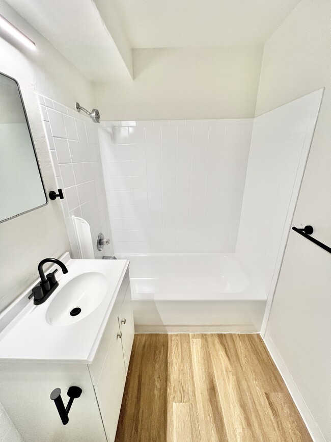 Experience luxury in this sleek modern bathroom, designed for style and comfort. - Melody Apartments