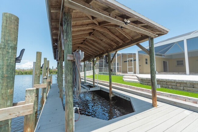 Building Photo - Live the ultimate Space Coast waterfront lifestyle at this stunning beachside canal home in Satel...