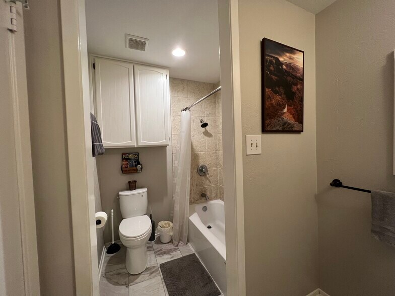 Toilet and shower in hall bathroom - 3920 Sanguinet St