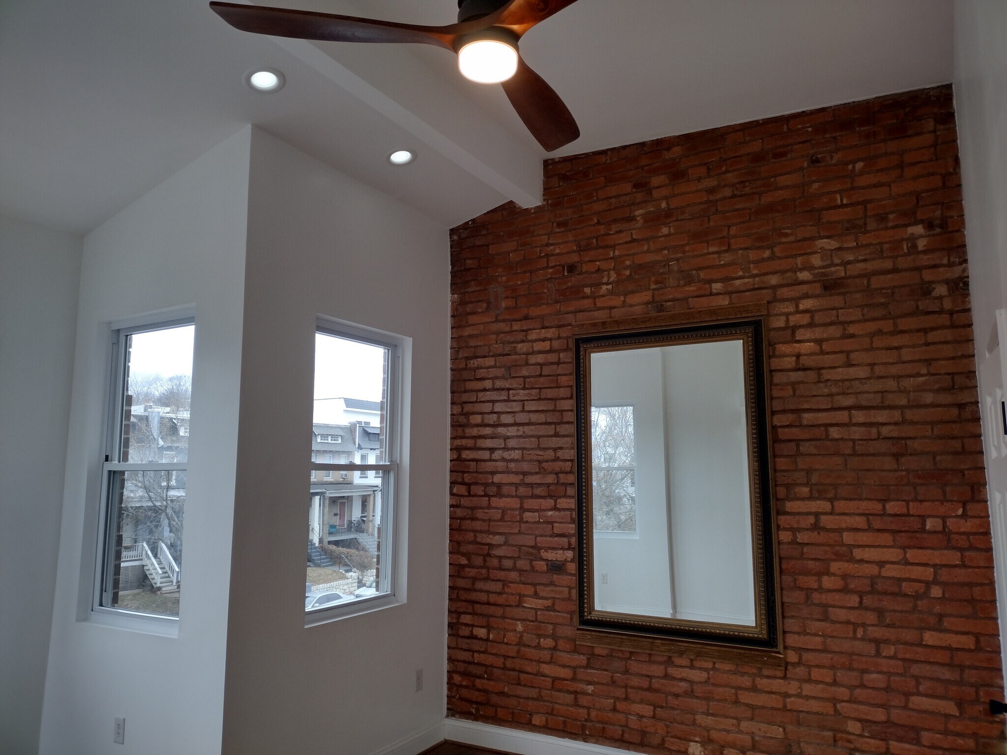 Primary Bedroom Expansive primary bedroom featuring five large windows that flood the space with nat - 1933 4th St NW
