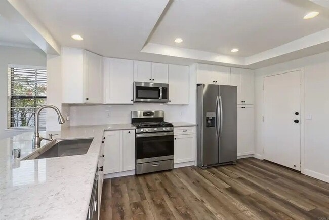 Building Photo - Upgraded La Costa Townhome