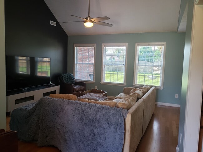 Living room offers vaulted ceilings, hardwood floors, and lots of natural light. - 820 Laramie Ct