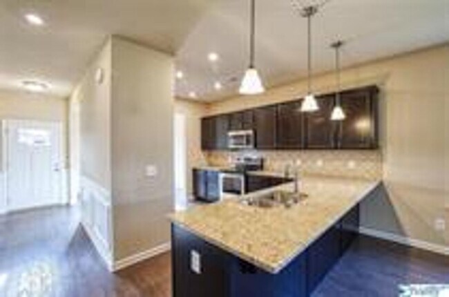 Building Photo - COMING SOON! Welcome to the Carlyle—where classic brick farmhouse charm meets a sleek, modern lif...
