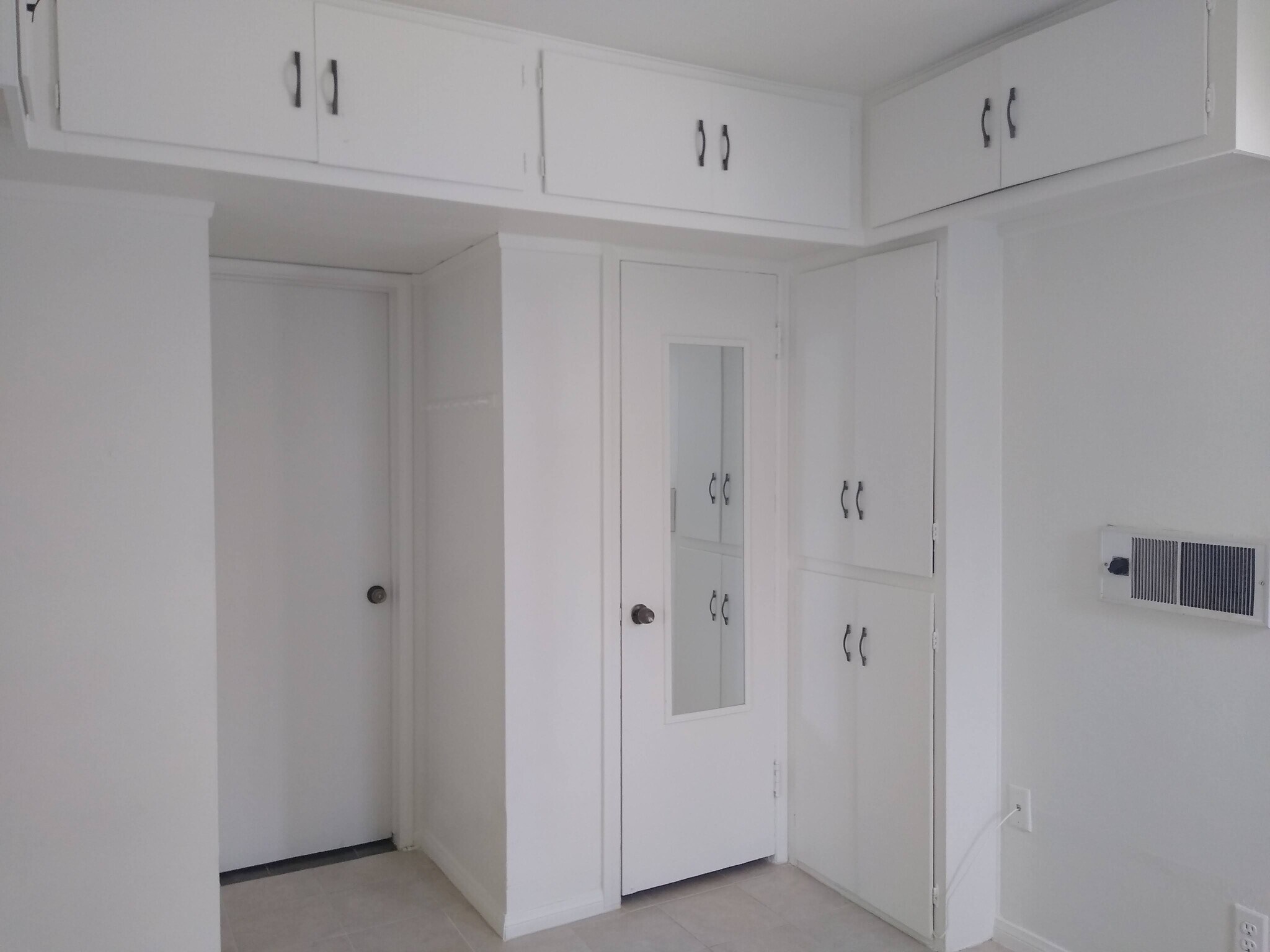 Bedroom. Cabinets and built-in wall heater. - 4127 Everts St