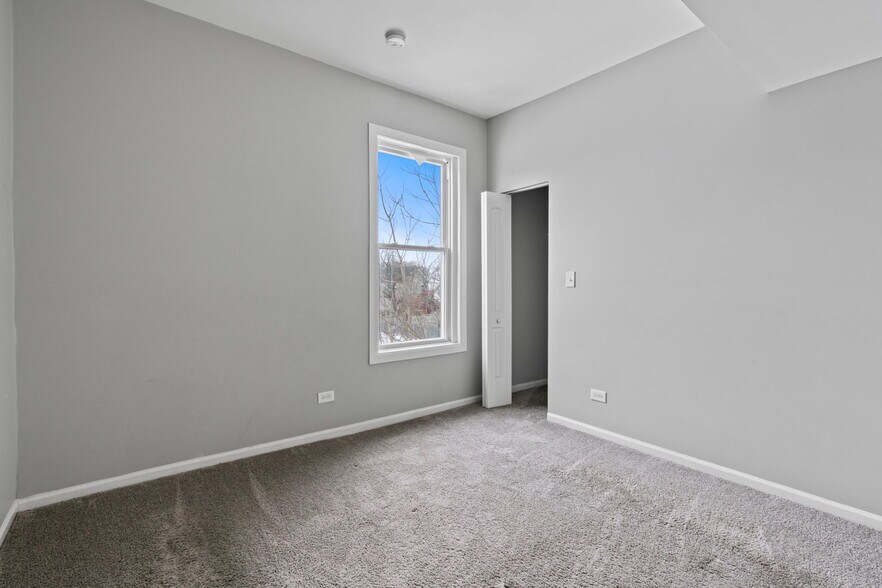 3 - Bedroom with private closet for additional storage. - 7028 S Peoria St