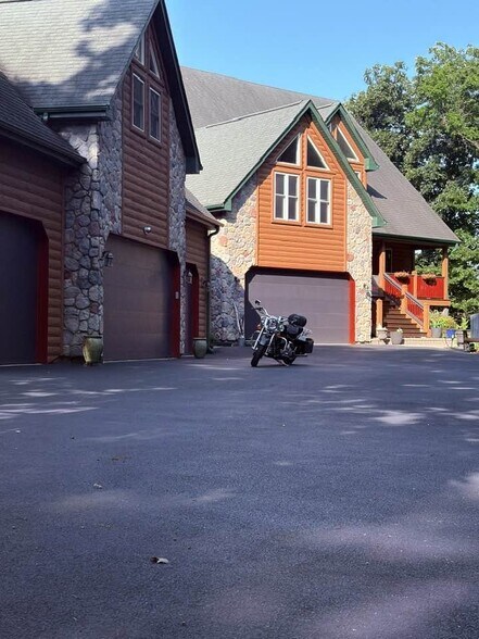 Front view. Rental apartment occupies the space above the 3 primary garages. - 5107 Timber Ln