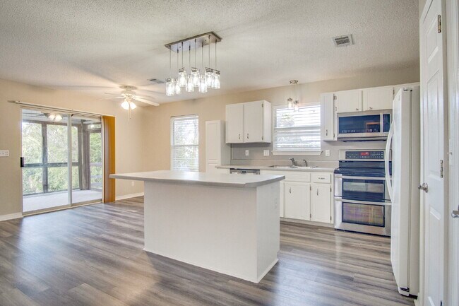 Building Photo - Live the Gulf Breeze Waterfront Life – Dock, Canal Access & Boat Lift!