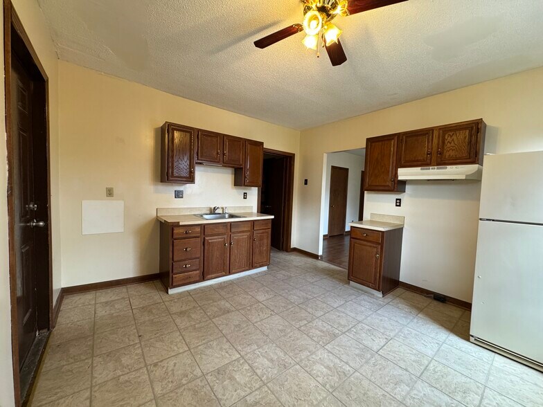 Kitchen w/ new glass top stove and new stainless fridge - 67 E Main St