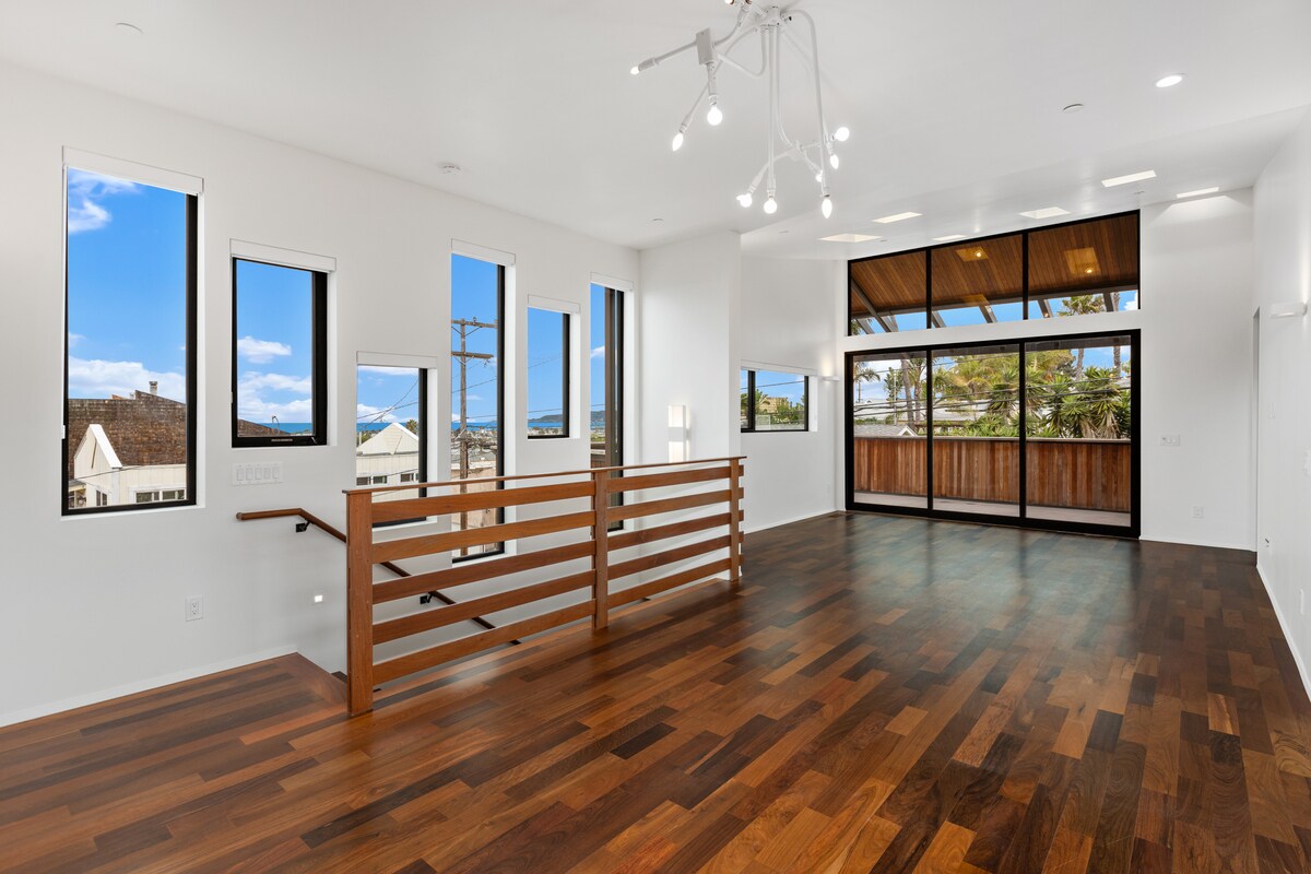 Dining area with peak ocean views through architectural windows. - 4640 Del Monte Ave