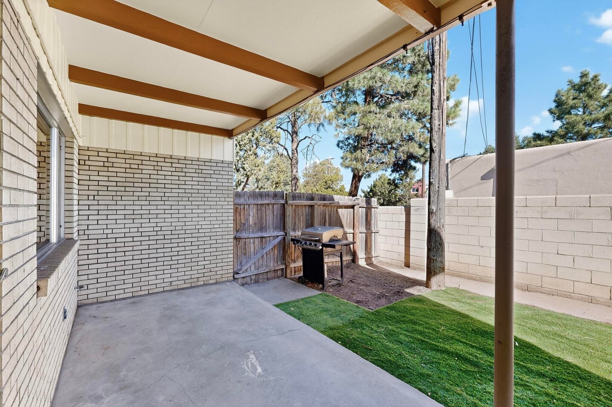 fully enclosed backyard with patio furniture, grill - 4715 Marquette Ave NE