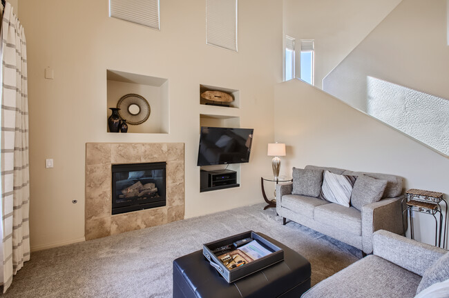 Living room with fireplace; stairway up to 2nd floor bedrooms - 19475 N Grayhawk Dr