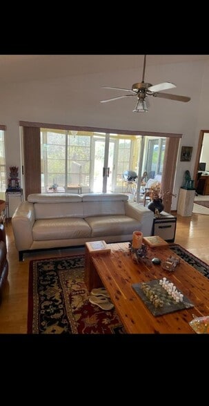 Living room view looking out onto the deck toward the water and backyard - 7639 Wells Ct
