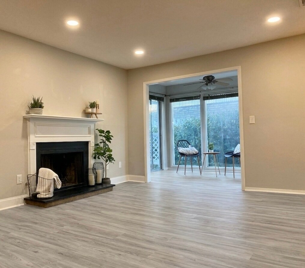 Livingroom with New LVP Floors and a Gas Fireplace - 1405 Vicksburg Plz