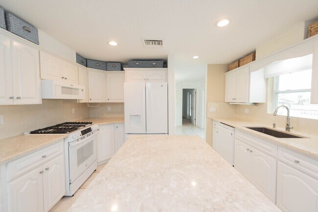 Building Photo - Live the ultimate Space Coast waterfront lifestyle at this stunning beachside canal home in Satel...