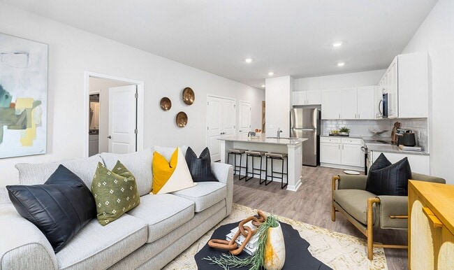 Modern open-concept living room and spacious kitchen - Covey Homes New Hampstead