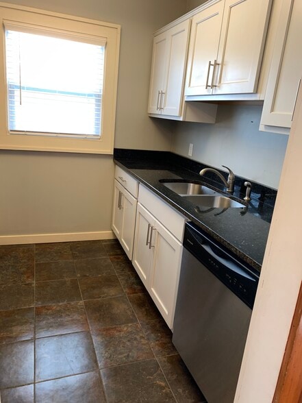 Cool galley kitchen with granite countertops, tile floor, stainless appliances - 4232 Urbandale Ave