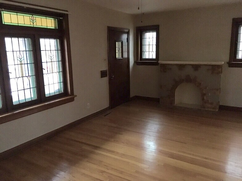 Living Room with art glass windows. - 6000 Carlsbad Avenue