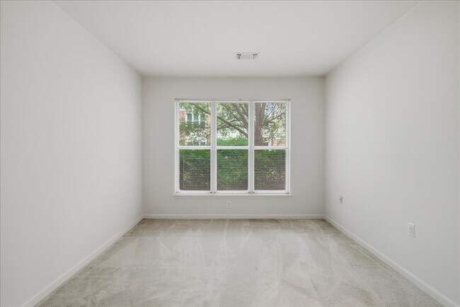Building Photo - Commuter’s Paradise! Ground-Level 2BR Condo  Welcome home to this stunning, sun-filled 2-bedroom ...