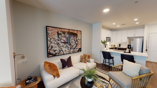 Open kitchen meticulously reimagined with two-tone cabinets, quartz counters, and stainless steel appliances - Alister Montclair