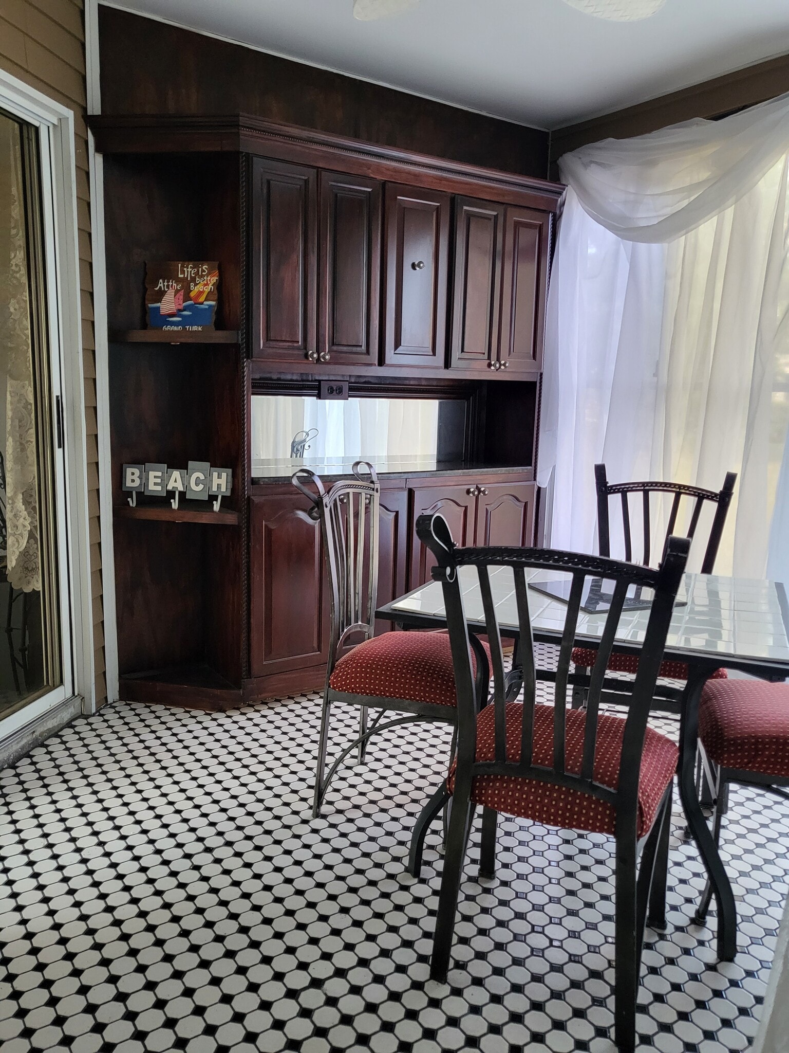 Tiled lanai with mahogany china cabinet - 10871 SW 90th Ct