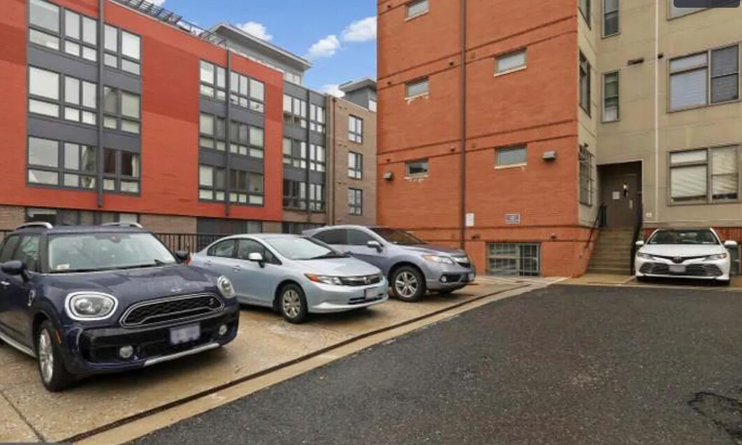 The safe and secure parking lot includes private spaces to rent. - 2910 Georgia Ave NW