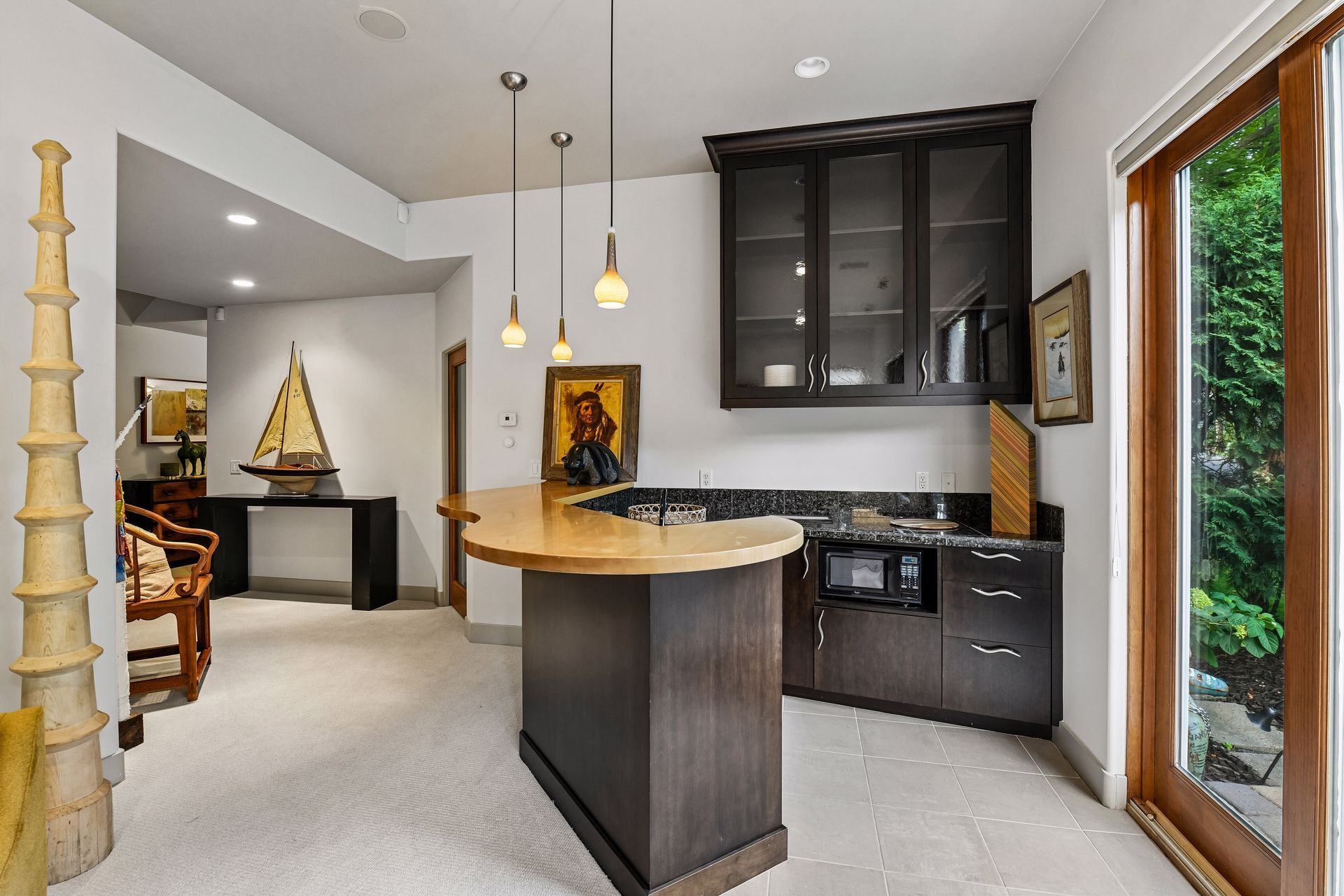 The lower level offers entertaining space, a wet bar, exercise room, and access to the walkout patio - 745 Rice St E