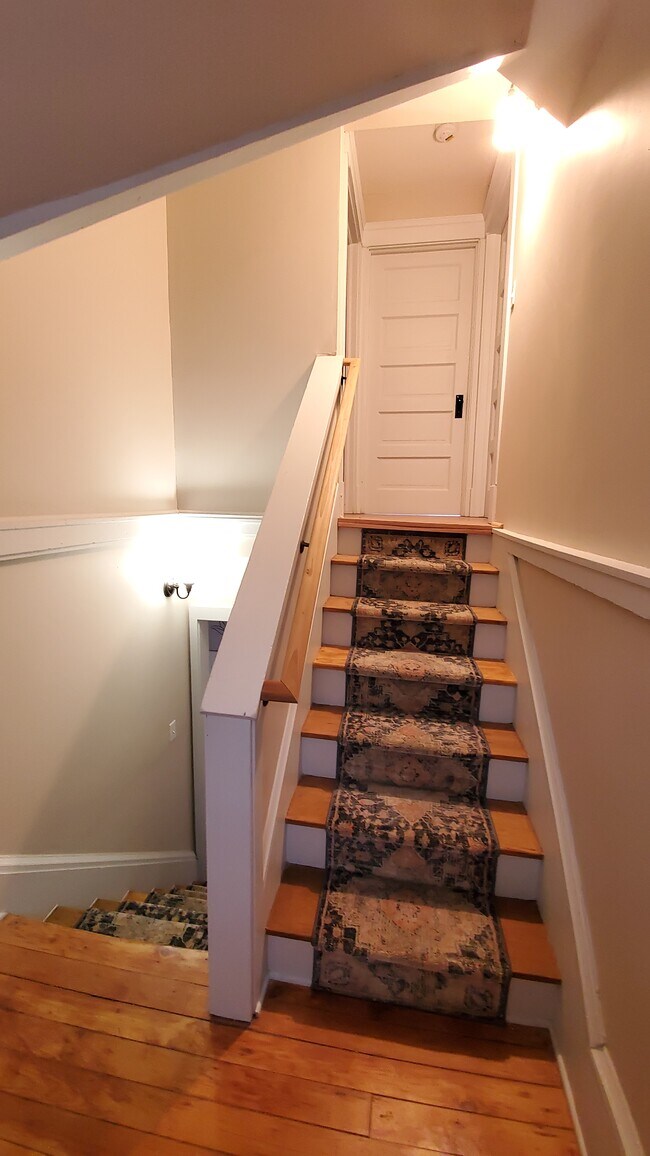 Hardwoid flooring with carpet runners throughout home - 1606 E 85th St