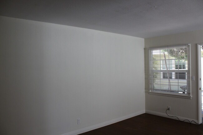 Living Room has one window looking out into courtyard - 4435 E Ocean Blvd