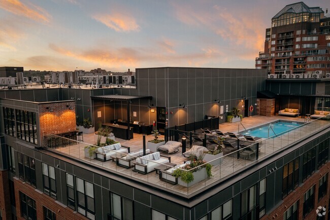 Rooftop lounge area featuring poolside seating and cabanas - The Asher