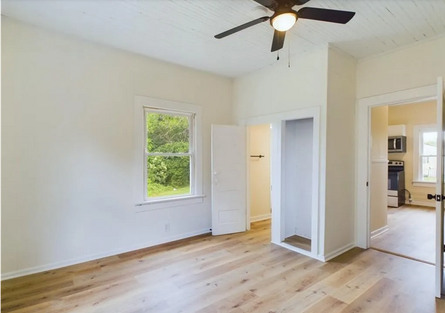 Bedroom 2/Flex Room:bright and versatile bedroom with two windows providing views of the backyard - 1011 Elm St