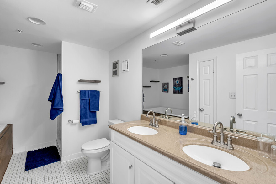 Upstairs full bath with soaking tub, shower, and double vanity. - 1000 Fell St