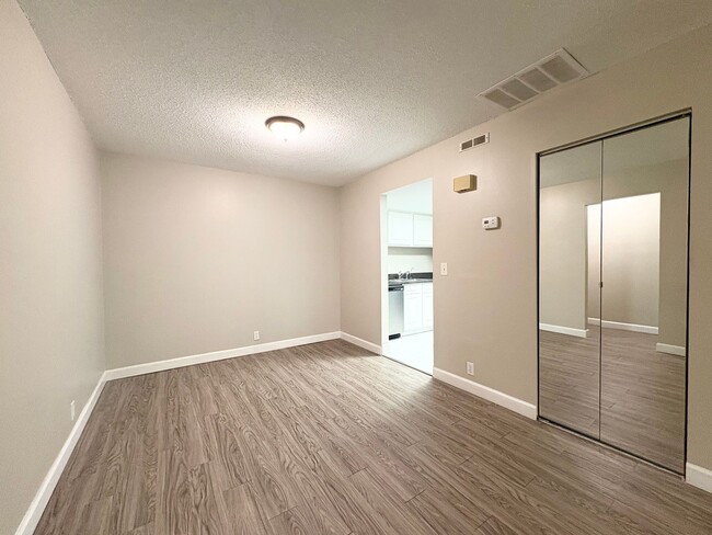 Building Photo - Beautiful Corner Unit with Vinyl Plank Flooring & Private Screened Patio