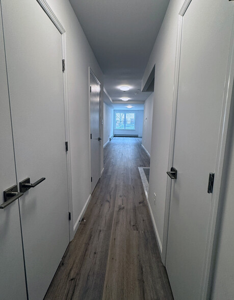 Hallway from bathroom looking towards front windows - 50 Buffalo Ave