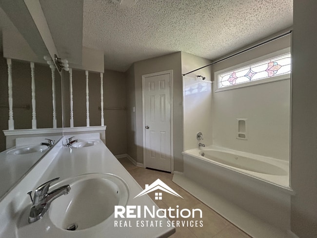 Building Photo - Spacious 4BR/2BA Near Southwind | High Ceilings, Brick Fireplace & 2-Car Garage