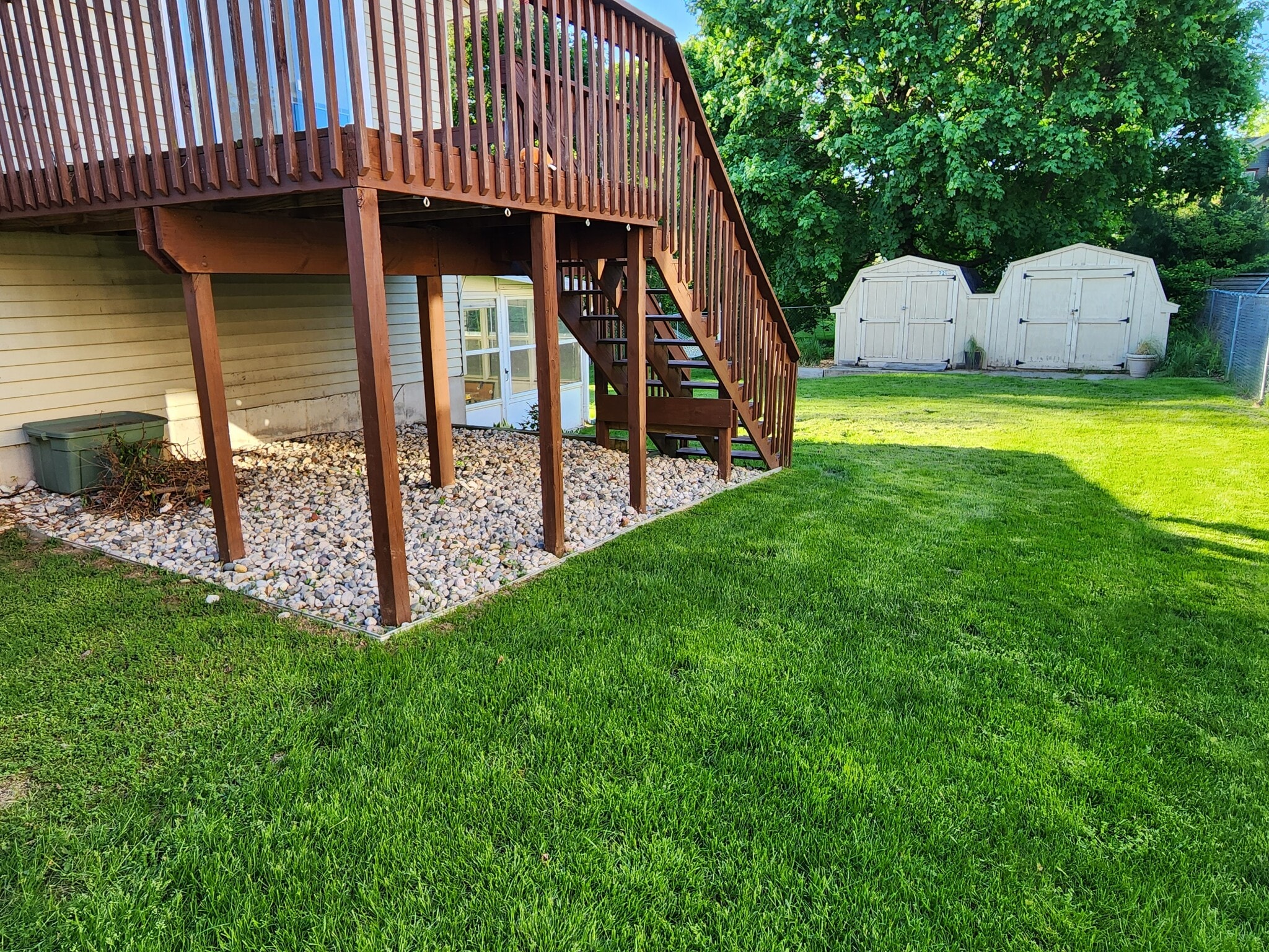 Deck with manicured lawn and low matience landscaping - 223 E Division St