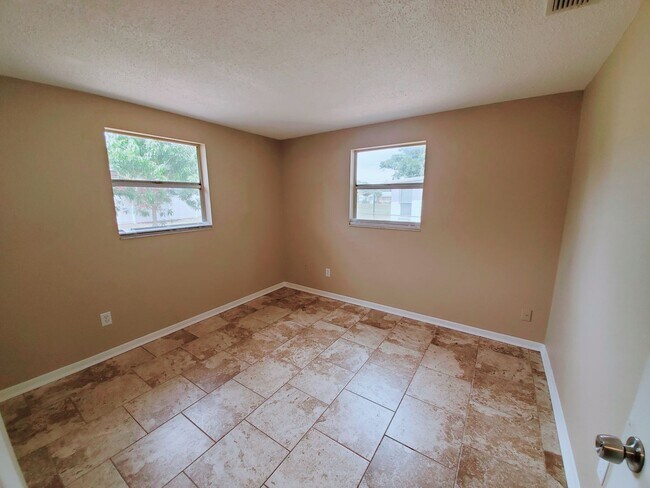 Building Photo - Three bedroom one and a half bathroom house with large yard space