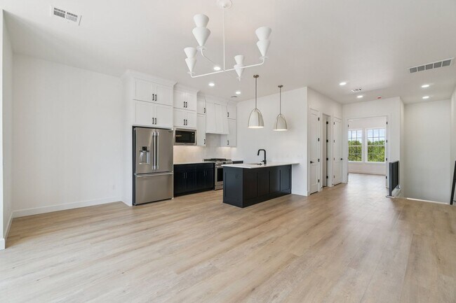 Building Photo - Bright. Clean. Calm. Your Elevated One-Bed...