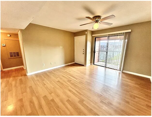 Open Living Room w/ Sliding Glass Doors - 904 University Oaks Blvd