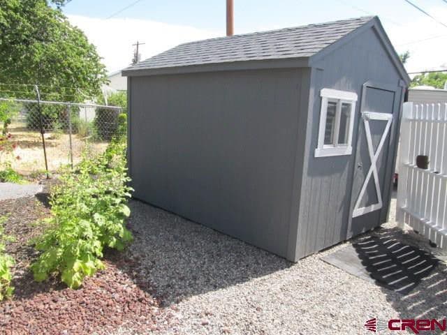 Shed in a fenced backyard. - 165 NW 2nd St
