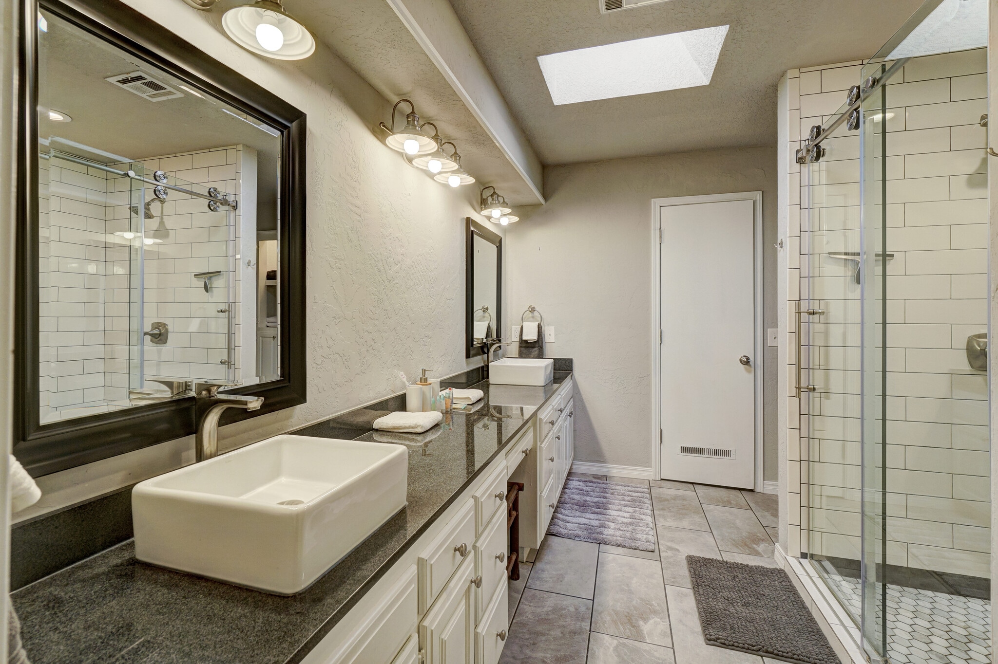 Master en-suite bathroom with double sink and large stand-in shower. - 3905 NW 70th St