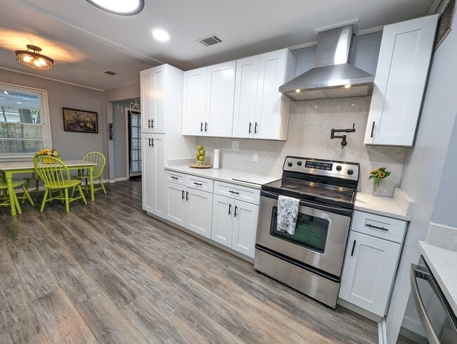 The kitchen has been recently renovated with modern amenities, stainless appliances, a dishwasher, l - 4107 Crane St