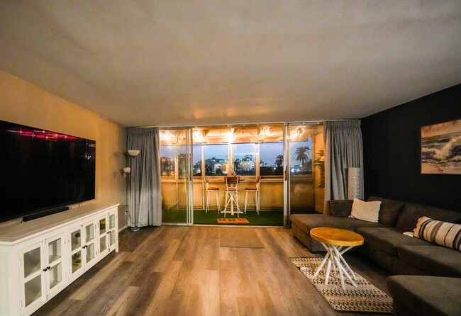 Night view of balcony with balcony overhanging lights on. - 1054 E 2nd St