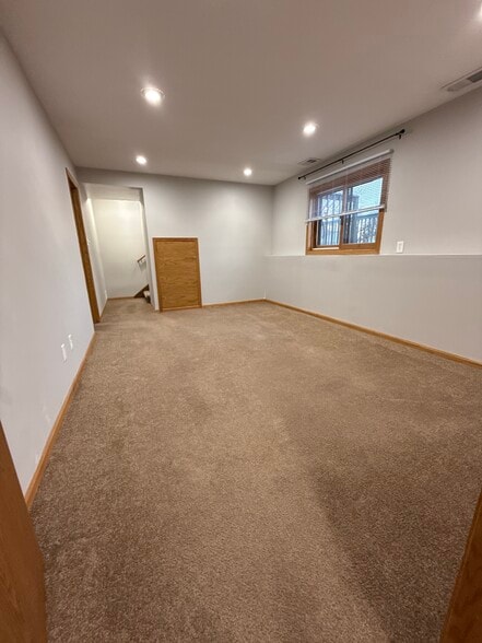 Lower-level family room with clean, open layout. - 9092 Goldenrod Ln N