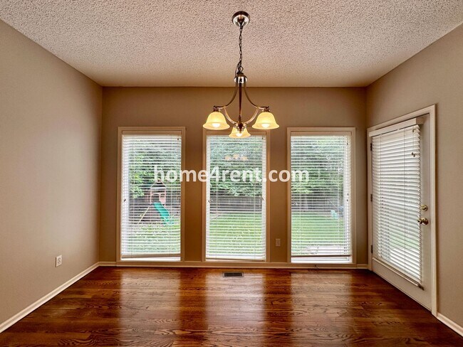 Building Photo - Beautiful Four-Bedroom Home with Three Car Garage, Wood Floors, Finished Basement and a Fenced Ya...