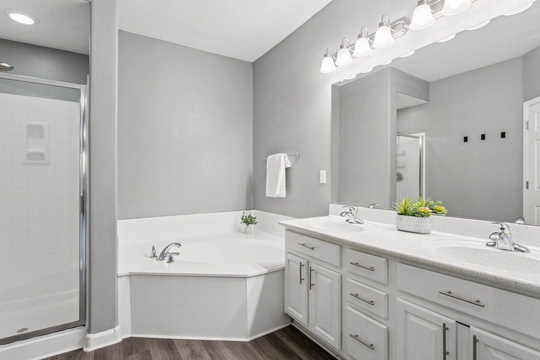 Ensuite bath has double sinks, soaking tub, and step-in shower - 14000 N 94th St