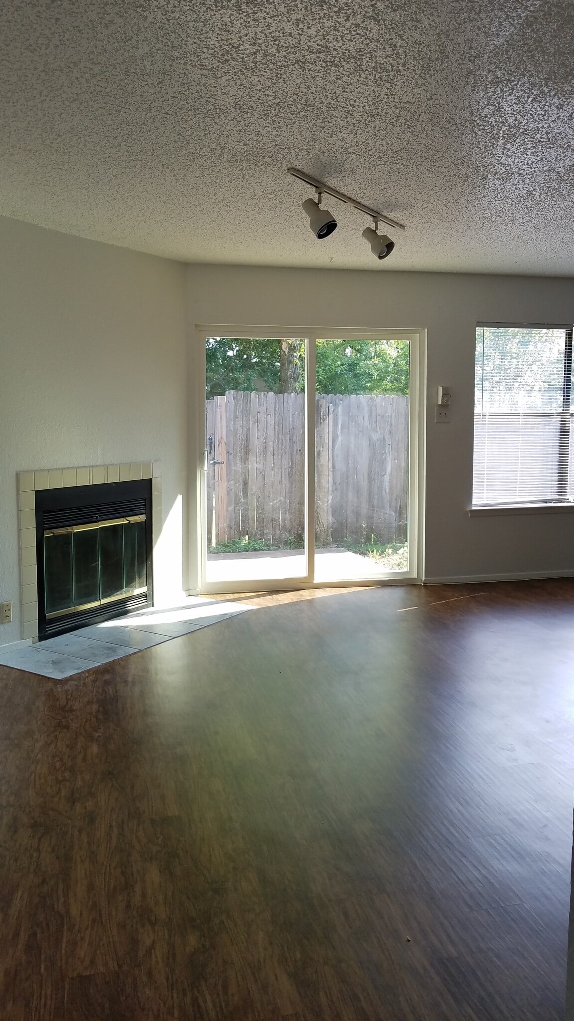 Living Room with WBFP and Fenced Patio - 7632 John T White Rd