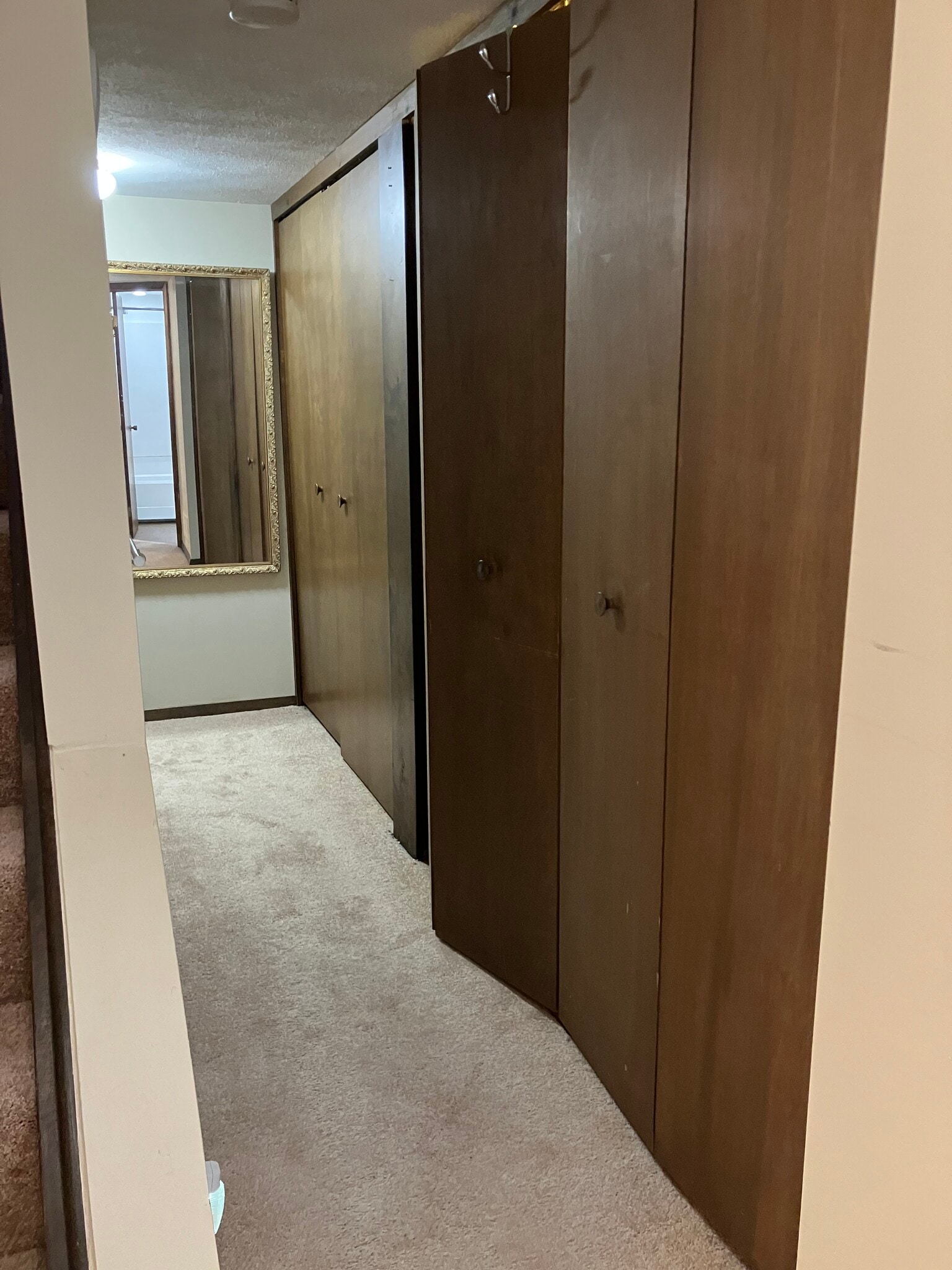 hall leading from bedroom #1 to bedroom #2, washer and dryer on right - 6344 Aurelia St